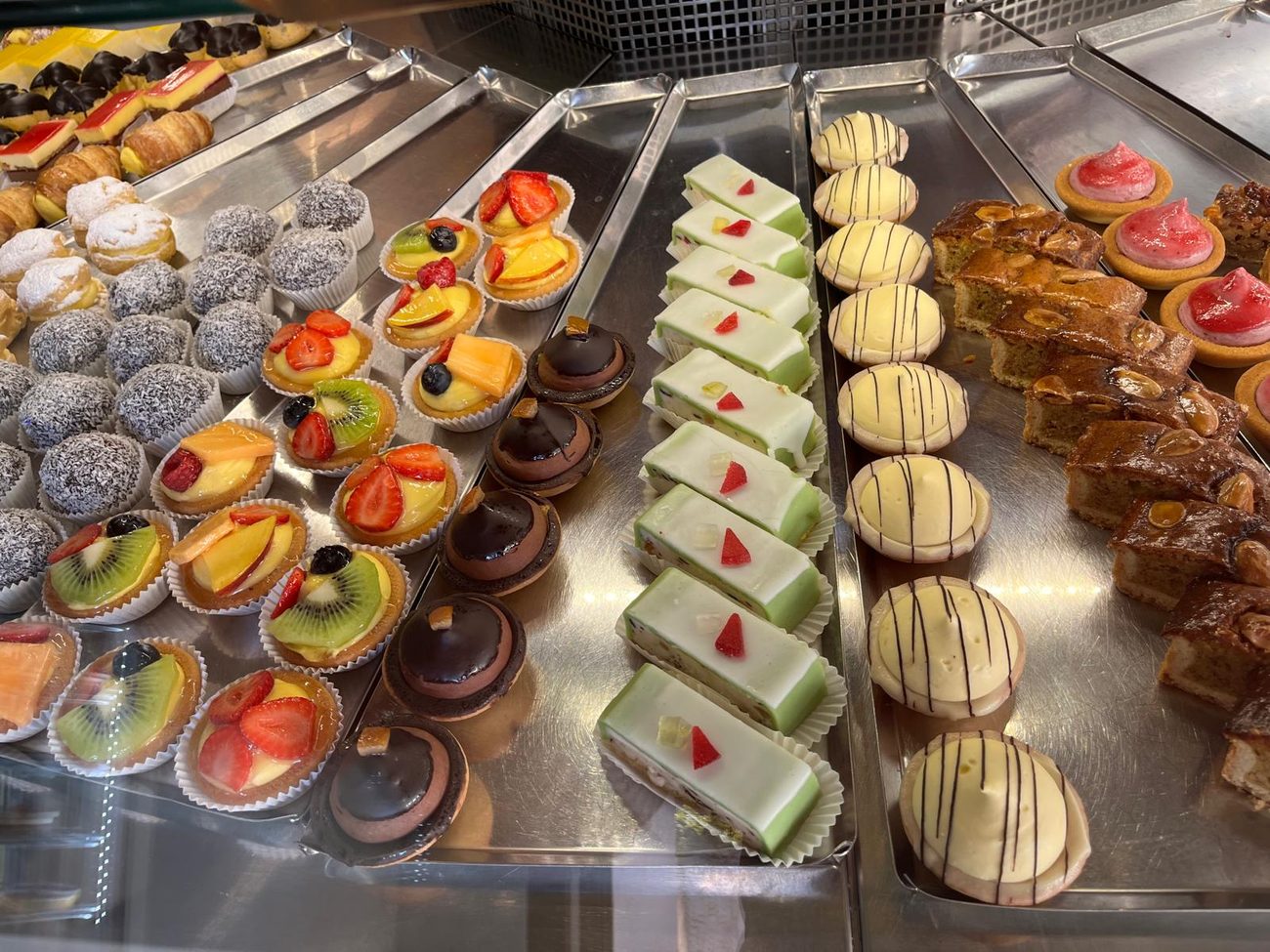 La vetrina della pasticceria mignon: tartellette alla frutta, monoporzioni e sfoglie